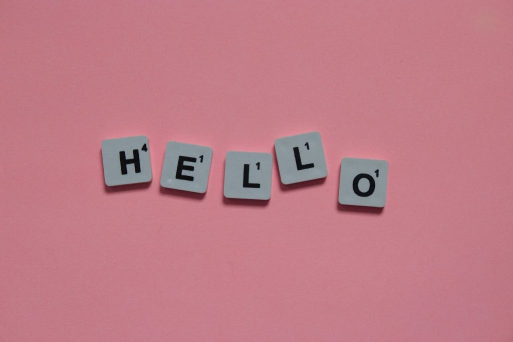 pexels photo 15702599 Scrabble tiles arranged to spell 'hello' on a soft pink background, with copy space.