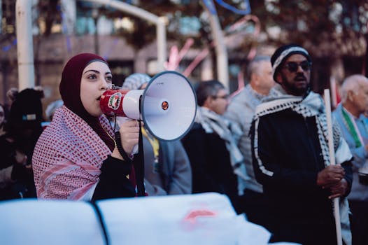 pexels photo 19544016 19544016 A woman speaks powerfully through a megaphone at an outdoor protest, engaging a diverse crowd.
