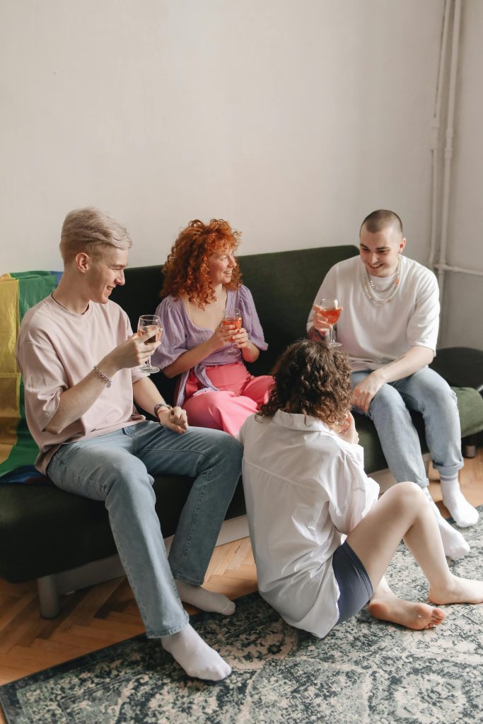 pexels photo 8555882 8555882 A group of friends enjoying a relaxed indoor gathering, sharing drinks.
